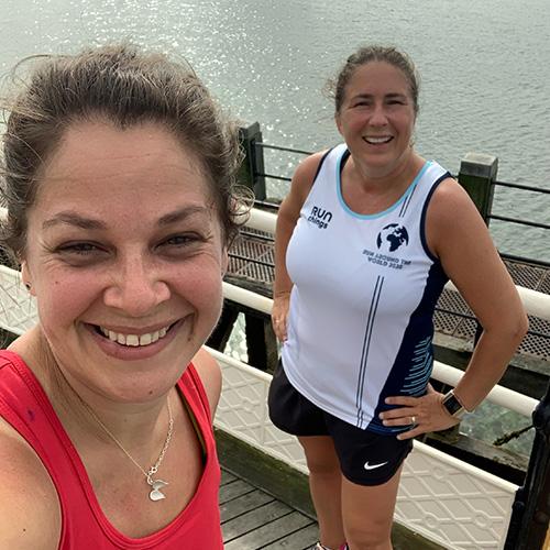 Lou Bolton smiling on a pier with friend